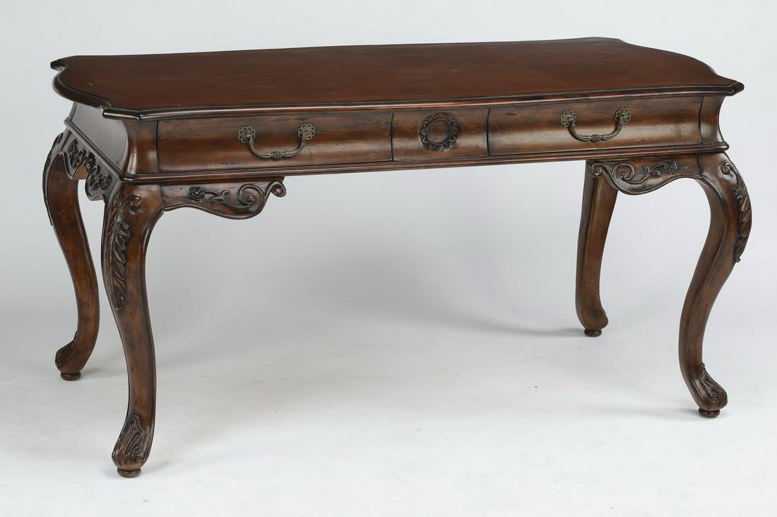Louis XVI style mahogany desk, 61"w: Hekman Furniture French Provincial style mahogany desk, having a shaped top with geometric parquetry inlay accents, above an apron with a central carved rosette flanked by drawers, the whole rising on
