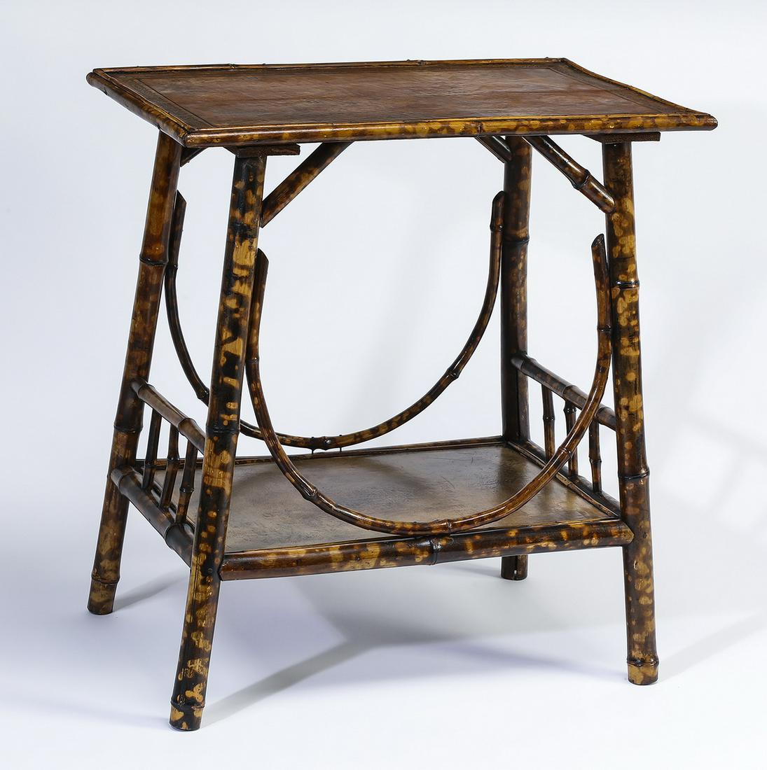 19th c. English bamboo and leather side table: English Victorian bamboo and leather side table, the rectangular top inset with embossed leather, rising on splayed legs joined by a lower shelf with conforming leather inset, 27.5"h x 24.5"l x 16.5"w