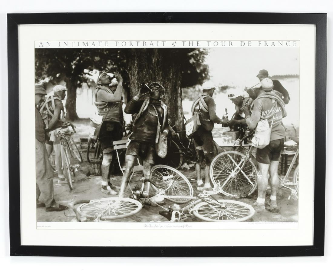 'Intimate Portrait of the Tour de France' photo print: Framed black & white photo print titled 'An Intimate Portrait of the Tour de France / Scenes Reminiscent of Renoir,' depicting bikers stopping for wine along the side of the road circa 1920s, 21.25"h 