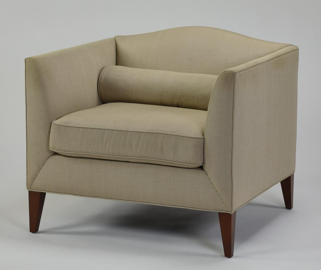 Baker Furniture upholstered tub chair in beige linen: Baker Furniture tub chair, in like-new condition, upholstered in beige linen with a loose seat cushion and bolster pillow, raised on square tapering legs, 32"h x 36.5"w x 34"d.