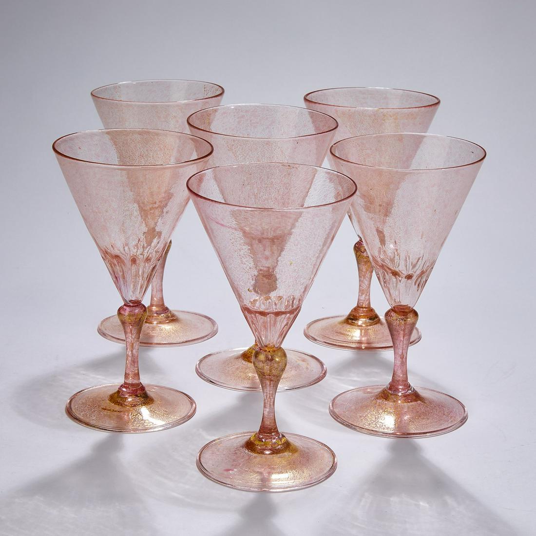 (6) Murano art glass wine goblets: (6) Murano art glass wine goblets in the manner of Salviati, executed in pink glass with gold dust flecks, each having a conical bowl tapering to gadrooning, and rising on a baluster stem, terminating