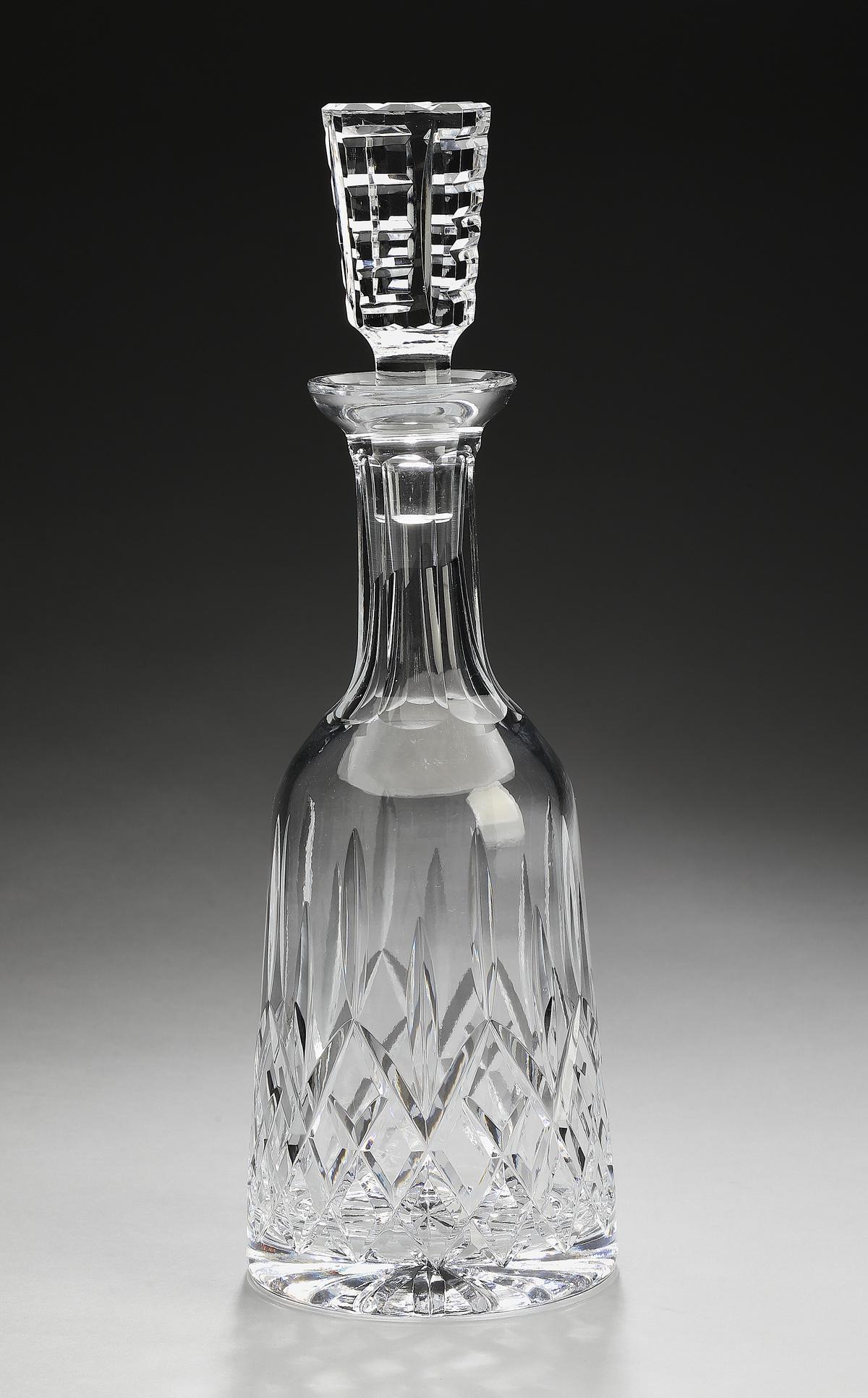 Waterford crystal 'Shannon Jubilee,' decanter: Waterford crystal decanter in the 'Shannon Jubilee,' pattern, having a rectangular notched stopper above a decanter with reserves centering ray cuts on a cross cut ground, maker marked, 13"h x 4.25"di