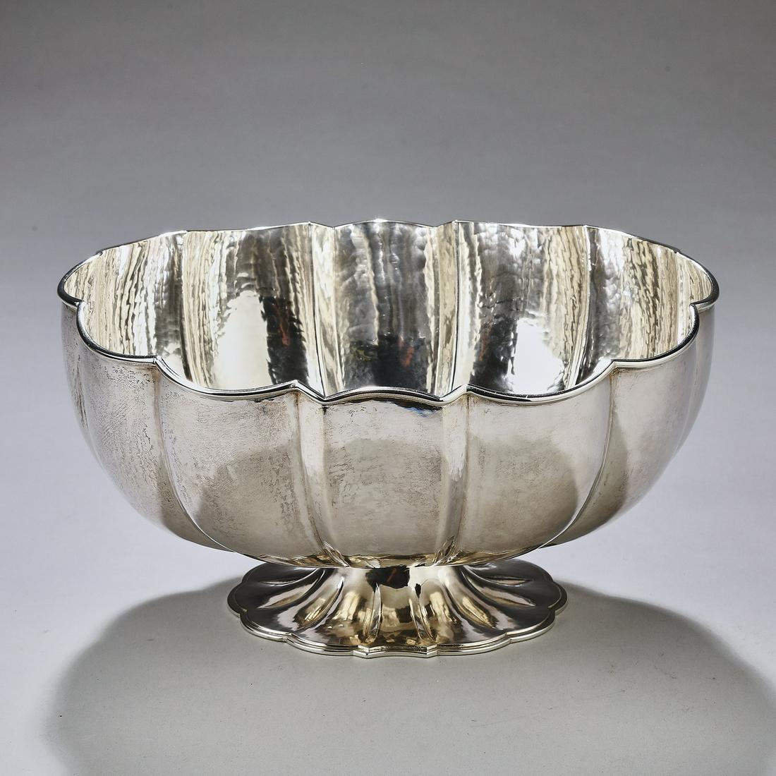 Buccellati hand raised sterling bowl: Buccellati hand raised sterling bowl, of oval melon form, rising on a gadrooned oval foot, maker marked on underside of foot rim, 4"h x 8"w x 6.5"d.