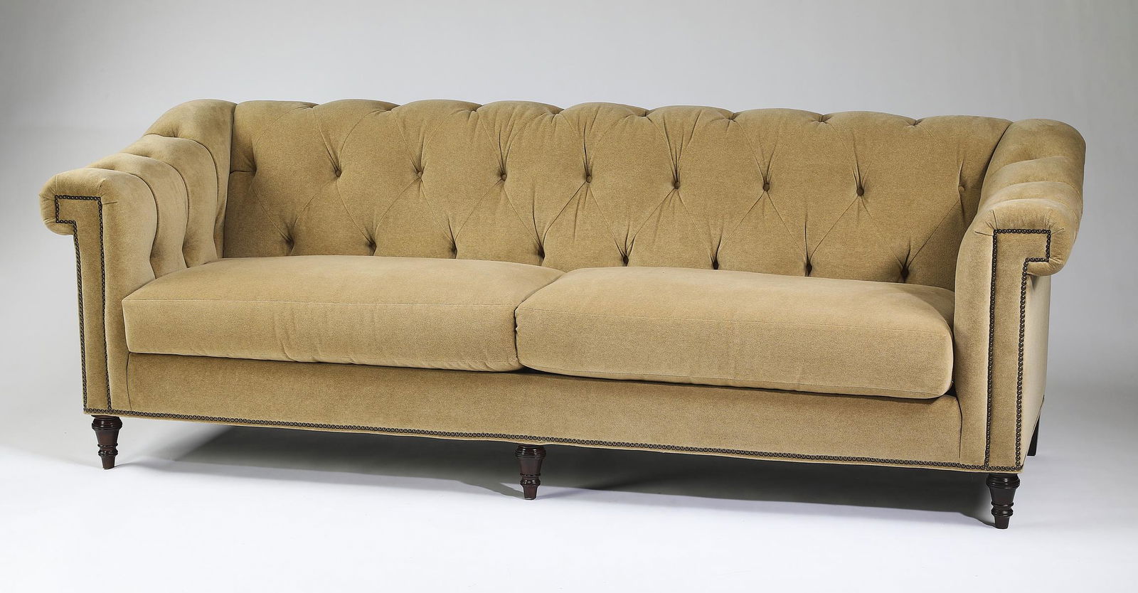 Sherrill Furniture sofa upholstered in mohair velvet: Sherrill Furniture tuxedo sofa, upholstered in a camel color mohair velvet, having button tufted back and arms, above two drop in seat cushions, ornamented with brass nail head trim, terminating to to