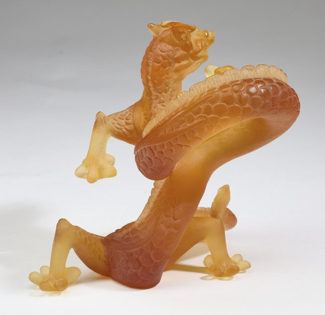 Daum France amber glass dragon figure, marked: Daum France satin finish amber glass dragon figure, the scaled body in a spiraling form, maker marked and numbered 1366, 5"h x 4.5"w x 5"d.