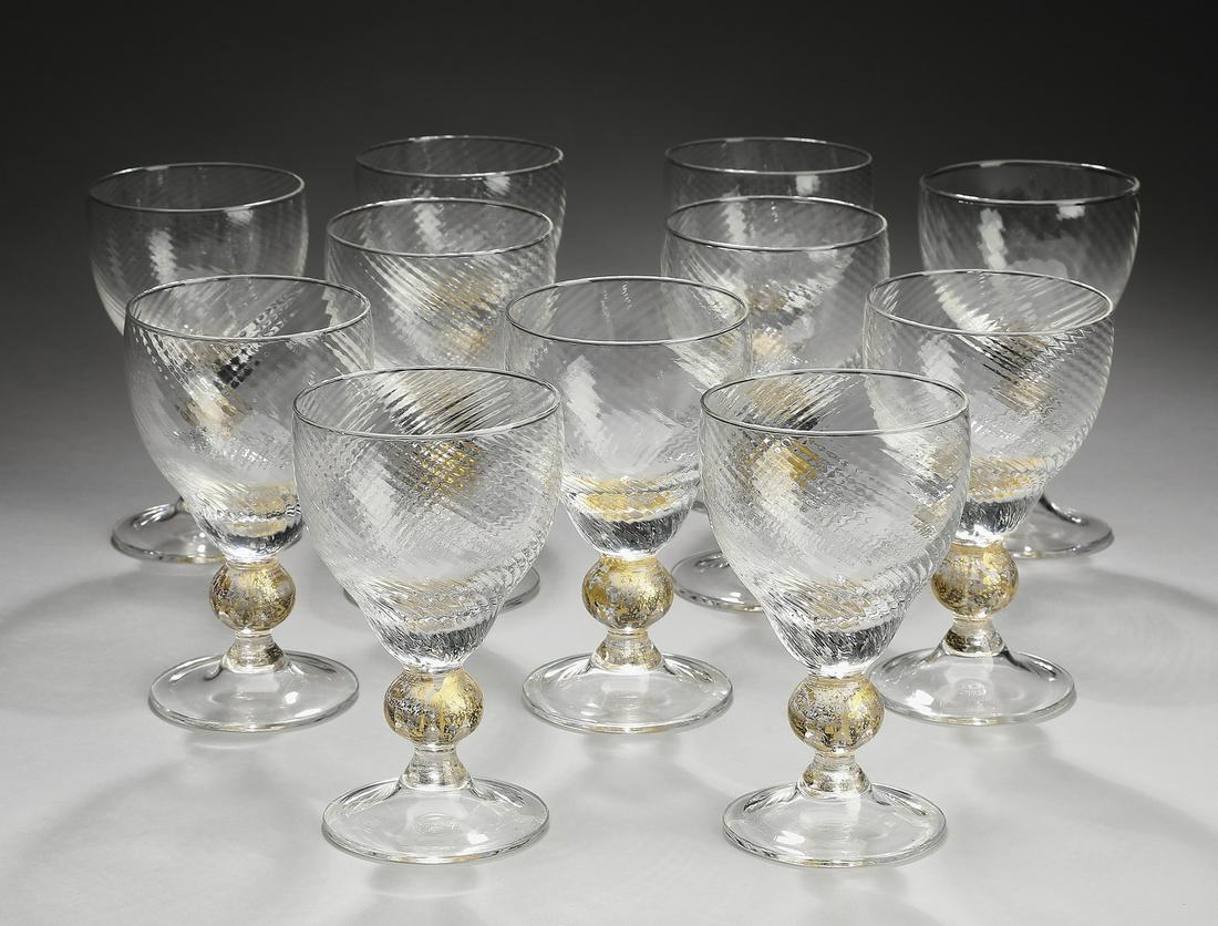 (11) Venetian gold flecked white wine glasses: Set of (11) Venetian white wine glasses, each have a ribbed optic bowl rising on a gilt splashed spherical knop, resting on a circular foot, having no apparent mark, 5.25"h