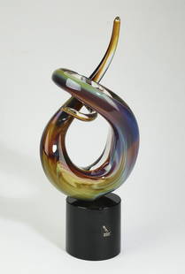 Oscar Zanetti signed abstract art glass sculpture: Oscar Zanetti (Italy, born 1961), art glass abstract sculpture, circa 1970, having amethyst, rose, blue, and yellow glass, rising on a solid black glass cylindrical base, signed and dated on the