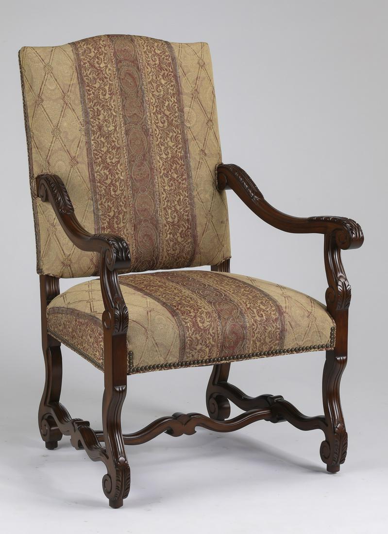 Charles X style carved mahogany armchair: Charles X style carved mahogany armchair, the back and seat upholstered in a banded tapestry fabric in beige, lavender, and mulberry hues, flanked by downward sloping foliate carved scrolling arms, ra