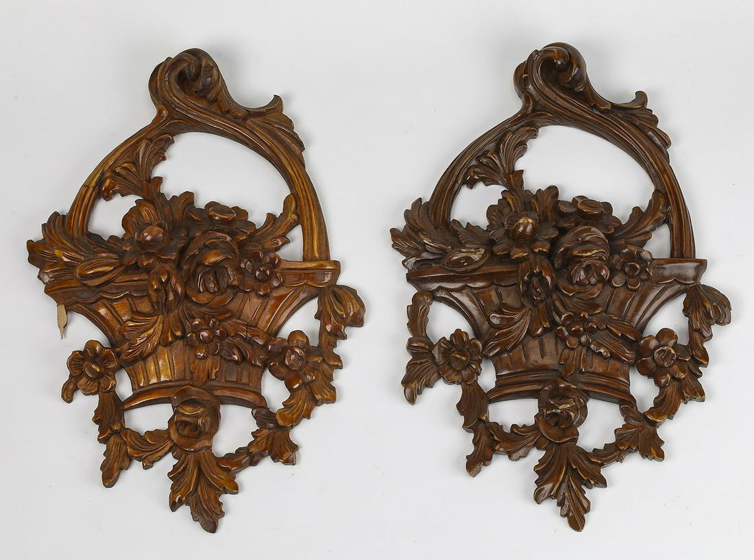 (2) Pierced and relief carved architectural appliques: Pair of pierced and relief carved architectural appliques, each in the form of an overflowing basket arrangement of abundant flowers, accented by garlands, 15"h x 10"w x 1.75"d.