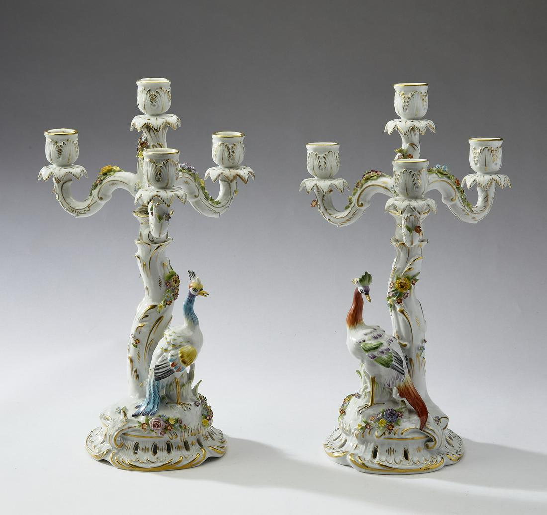 (2) Plaue Schierholz porcelain figural candelabra: Pair of Plaue Schierholz hand painted porcelain candelabra, in the Meissen taste, circa 1907-1927, each having four bobeches issuing from a naturalistic standard accented with foliates, terminating in