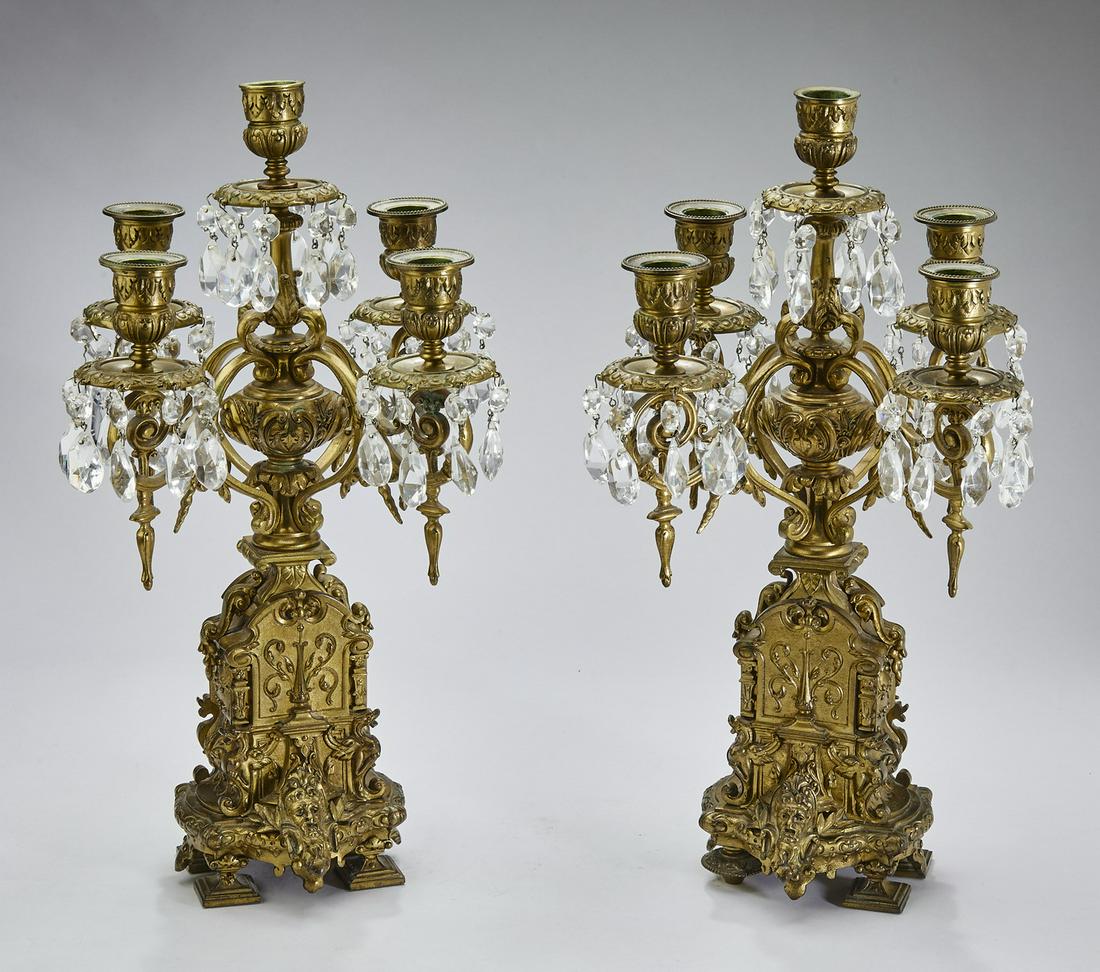 (2) Early 20th c. brass and crystal candelabra: Pair of Renaissance Revival candelabra, late 19th or early 20th century, executed in gilt brass and crystal, each having an urn form standard issuing five scrolling arms terminating to bobeches hung w