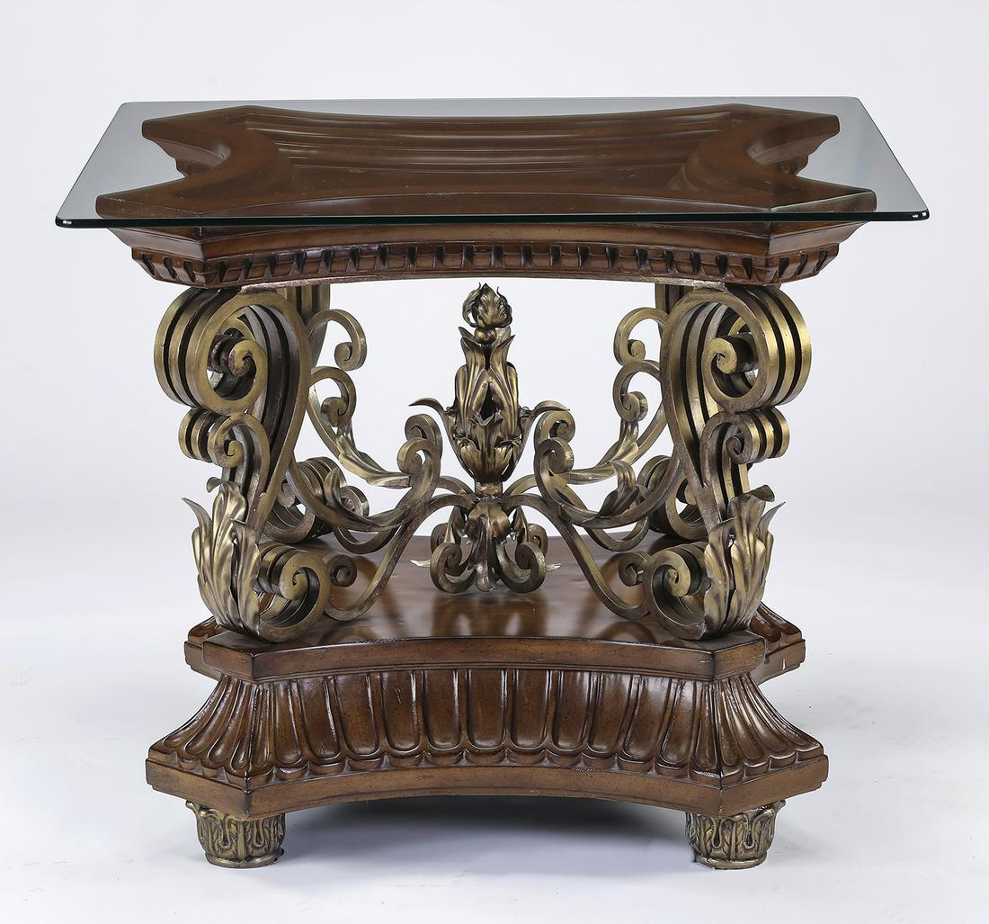 Maitland Smith style mahogany and gilt metal table: Maitland Smith style side table, executed in glass, gilt metal, and mahogany, having a square glass top resting on an ogee frame with carved dentil detailing surmounting gilt metal scrolled supports j