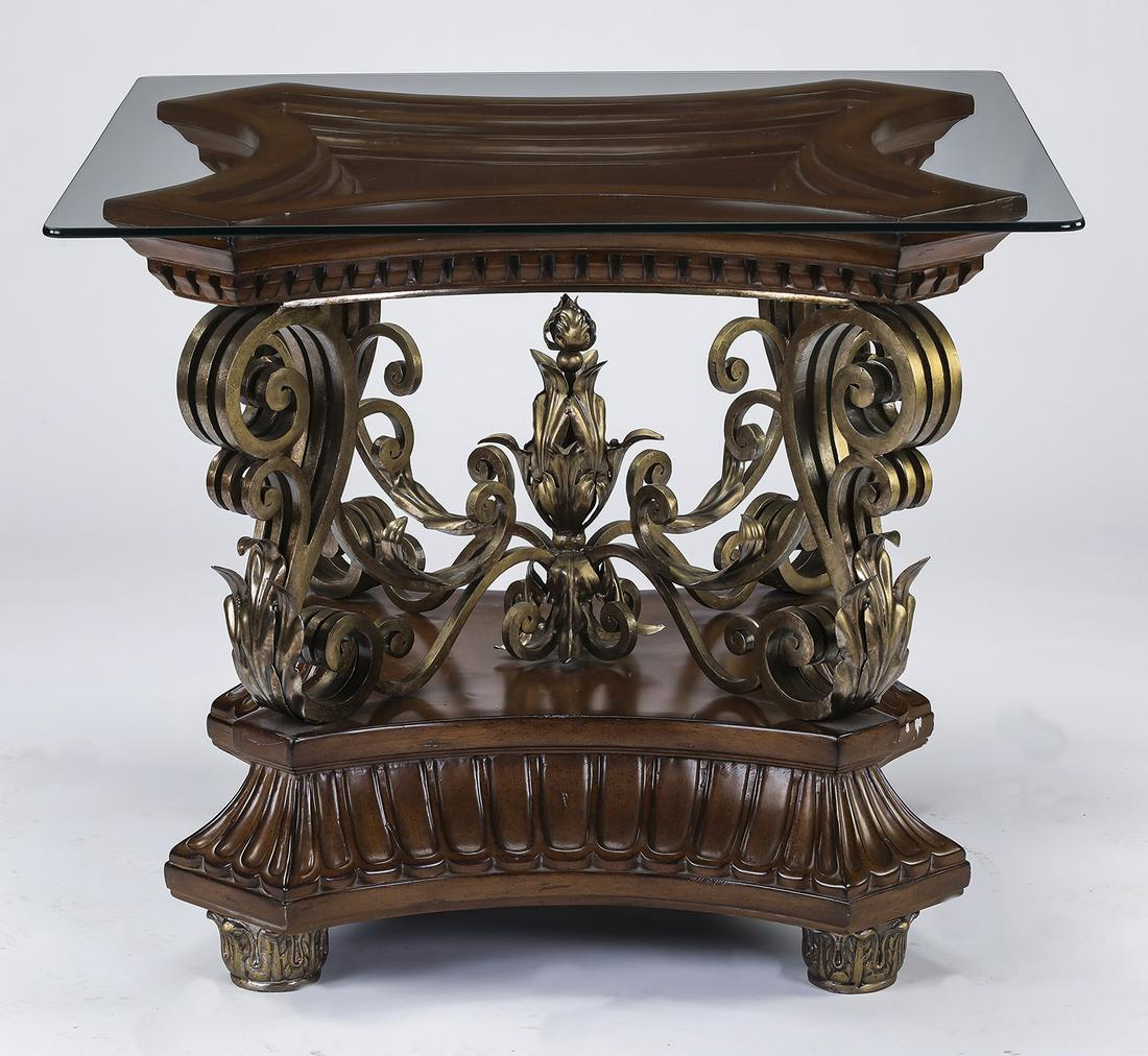 Maitland Smith style mahogany and gilt metal table: Maitland Smith style side table, executed in glass, gilt metal, and mahogany, having a square glass top resting on an ogee frame with carved dentil detailing surmounting gilt metal scrolled supports j