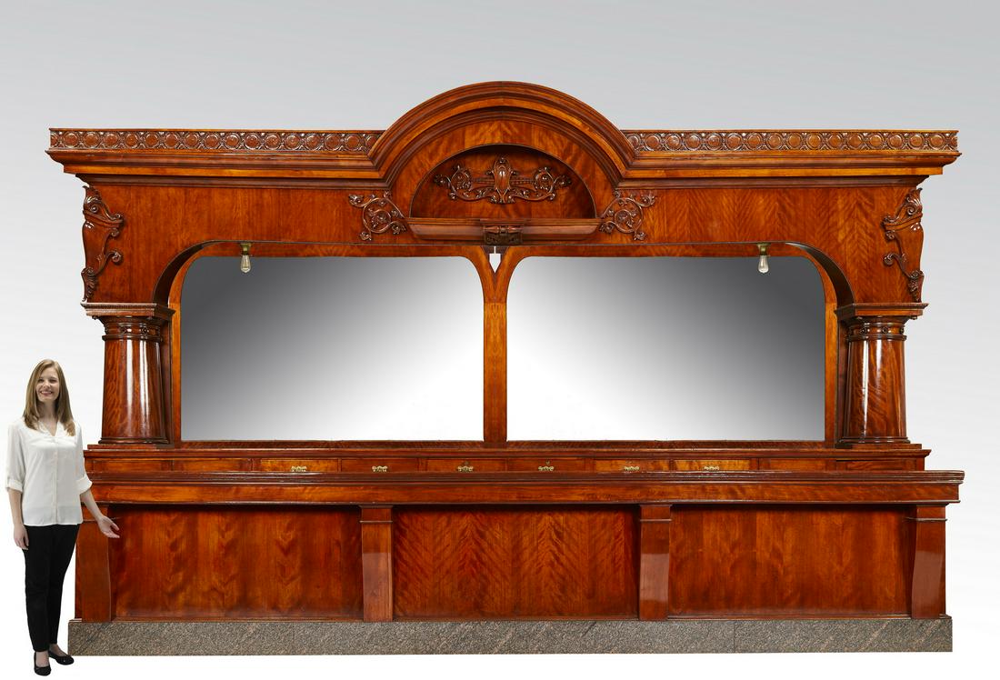 19th c Brunswick Metropolitan single arch bar, 124"h: Two piece monumental mahogany Brunswick Metropolitan single arch bar in the Rococo taste, 19th century, having front and back components, the back centering an arched and molded cornice above a relief
