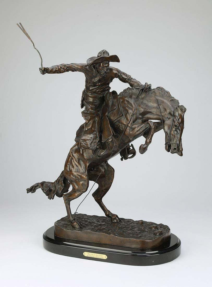 Bronze 'Bronco Buster,' after F. Remington, 26"h: Bronze 'Bronco Buster,' after Frederic Remington (American 1861-1909), depicting a weathered cowboy sitting astride a rearing horse, the whole resting on a naturalistic base with a marble plinth, 26"h