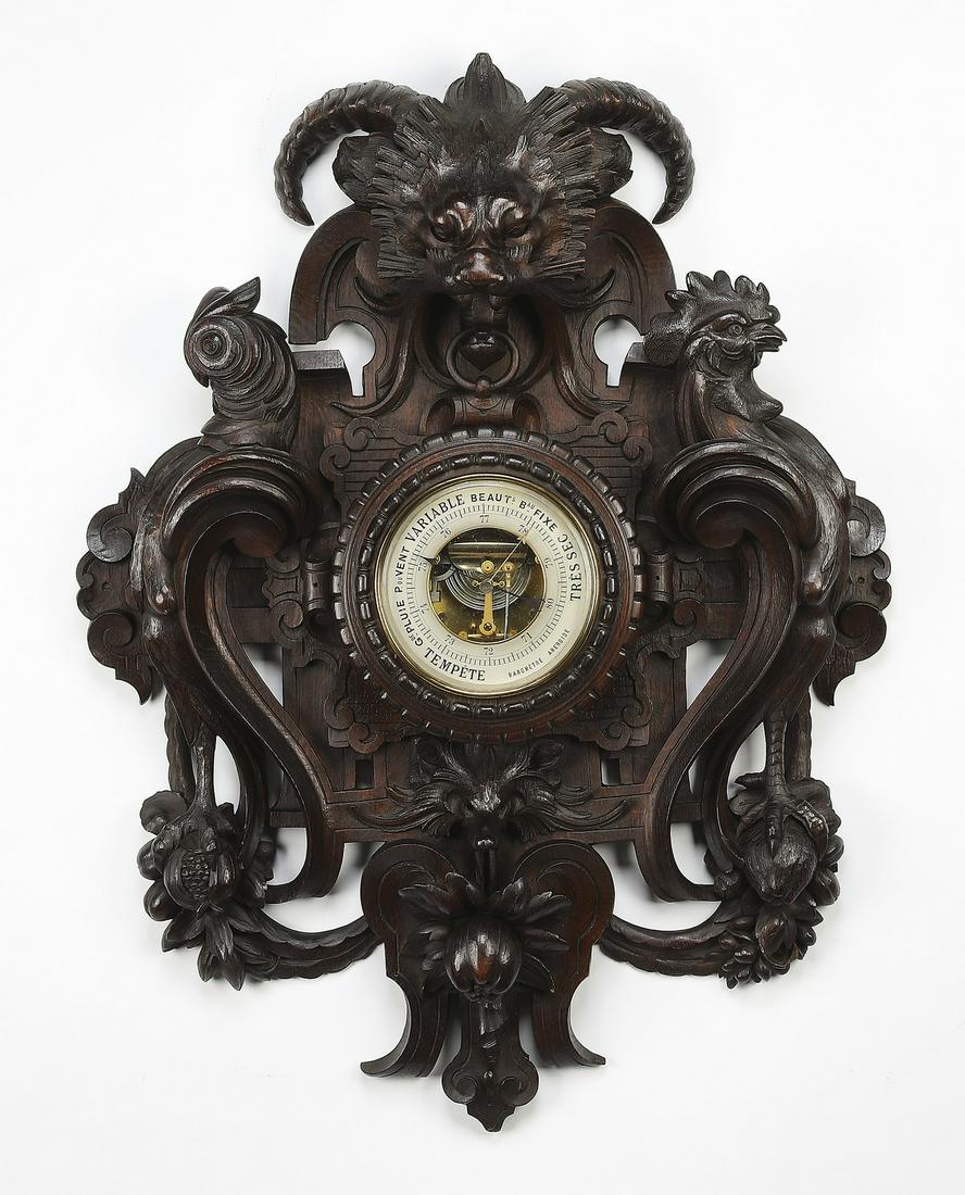 19th c. highly carved French oak barometer: French Renaissance Revival carved oak barometer, mid to late 19th century, the highly carved frame depicting a horned grotesque mask surmounting the dial, under glass with Arabic numerals, flanked by
