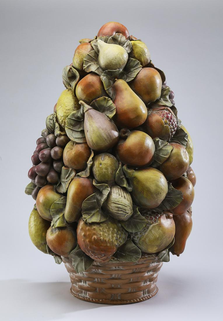 Capodimonte style fruit topiary centerpiece: Capodimonte style fruit topiary centerpiece, executed in terracotta, having clusters of grapes, pears, figs, strawberries, and pomegranates arranged in a cone form, surmounting a woven basket, 23"h x
