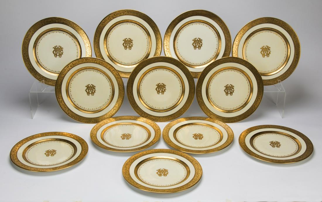 (12) Bavarian monogrammed porcelain plates: Set of twelve porcelain cabinet plates, Bavaria, each having an encrusted gold decoration with painted ebonized accents of trailing foliage vines on the wide rim, centering a gold encrusted monogram o