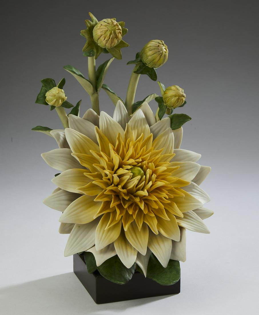 Cybis retired porcelain flower study of a Dahlia: Cybis retired porcelain flower study of a Dahlia, circa 1964, designed by Marylin Chorlton, depicting a fully bloomed yellow dahlia backed by buds, resting on a square wooden base, from an edition of
