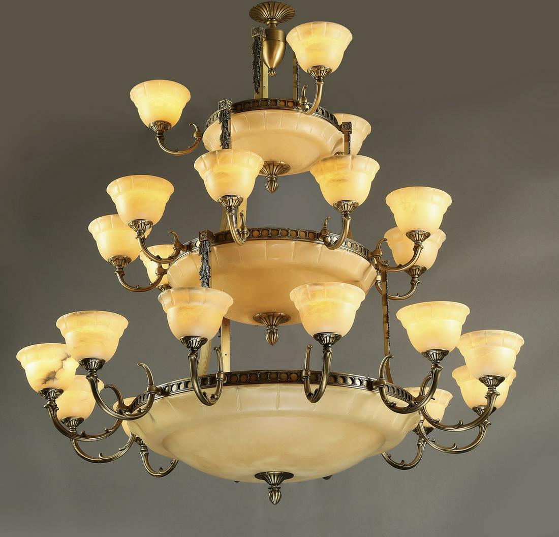 Empire style bronze and alabaster 24-light chandelier: Empire style bronze and alabaster chandelier, having 24 lights arranged in three graduated tiers, each tier centers an alabaster dome, issuing C-shaped foliate arms supporting a floral shaped alabaste