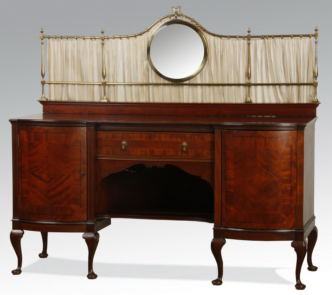 19th c. English mahogany buffet w/ bullseye mirror: 19th century English Queen Anne-style mahogany inlaid buffet with a double bombe' front and arch top brass gallery supporting a central bullseye mirror, 66"h x 72"w x 27"d.