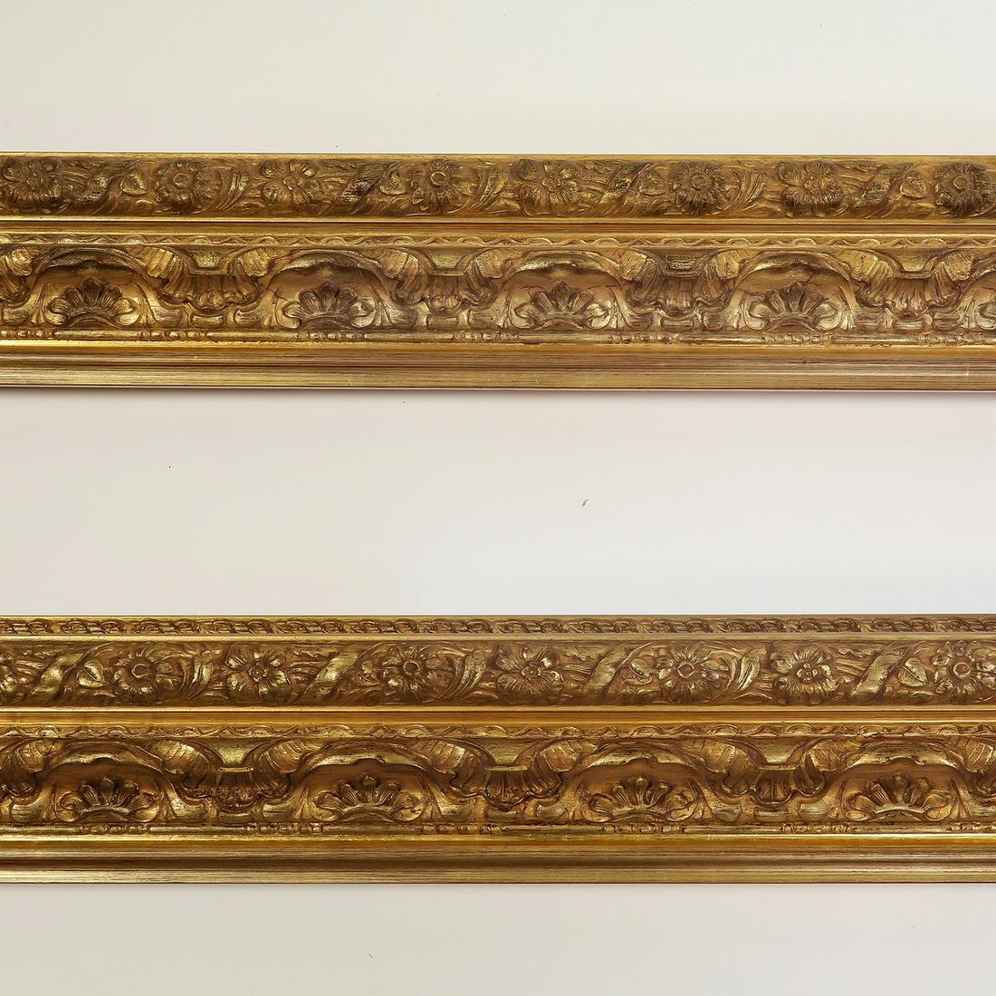 (2) Italian carved and gilt decorative moldings, 118": Pair of Italian carved and gilt decorative moldings, having floral, scallop, and ribbon borders, each measuring 5"h x 118.5"l x 2.5"d.