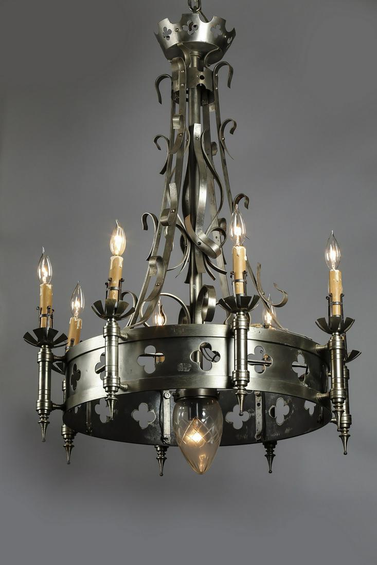 19th c. French polished iron chandelier: French Gothic Revival 9-light polished iron chandelier, late 19th century, having a canopy pierced with quatrefoils above a standard issuing eight arms with attached scrolling iron accents, joined by 