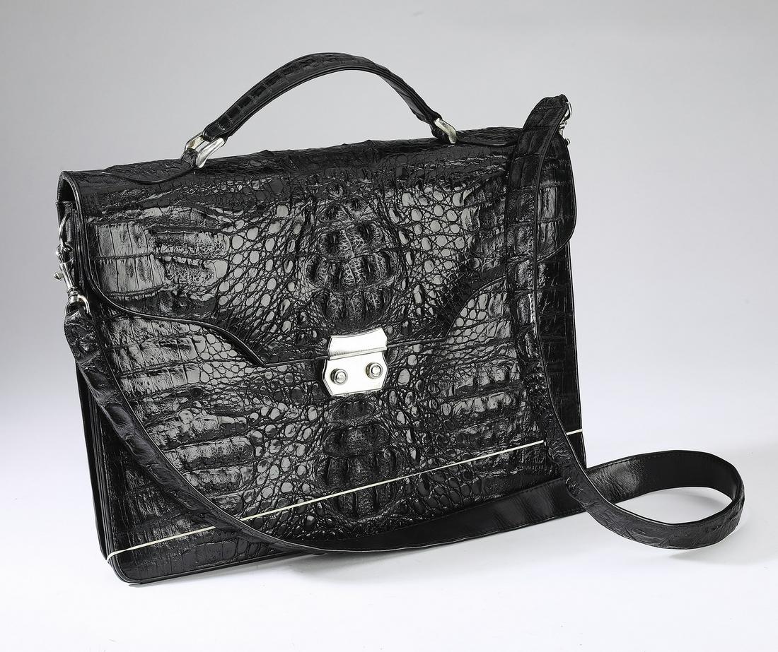 Black crocodile leather shoulder bag: Black crocodile leather briefcase shoulder bag, having a hand grip and shoulder strap, opening to card holders and a slip pocket, fitted with two compartments with a pen holder and pockets, marked 'P.