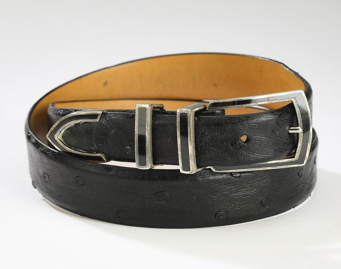 Black ostrich ranger belt w/ inlaid sterling buckle: Ostrich leather ranger belt with inlaid sterling buckle by Douglass Magnus, the black belt having a sterling buckle inlaid with thin black stone, two loops and a tip, marked 'Magnus sterling,' men's s