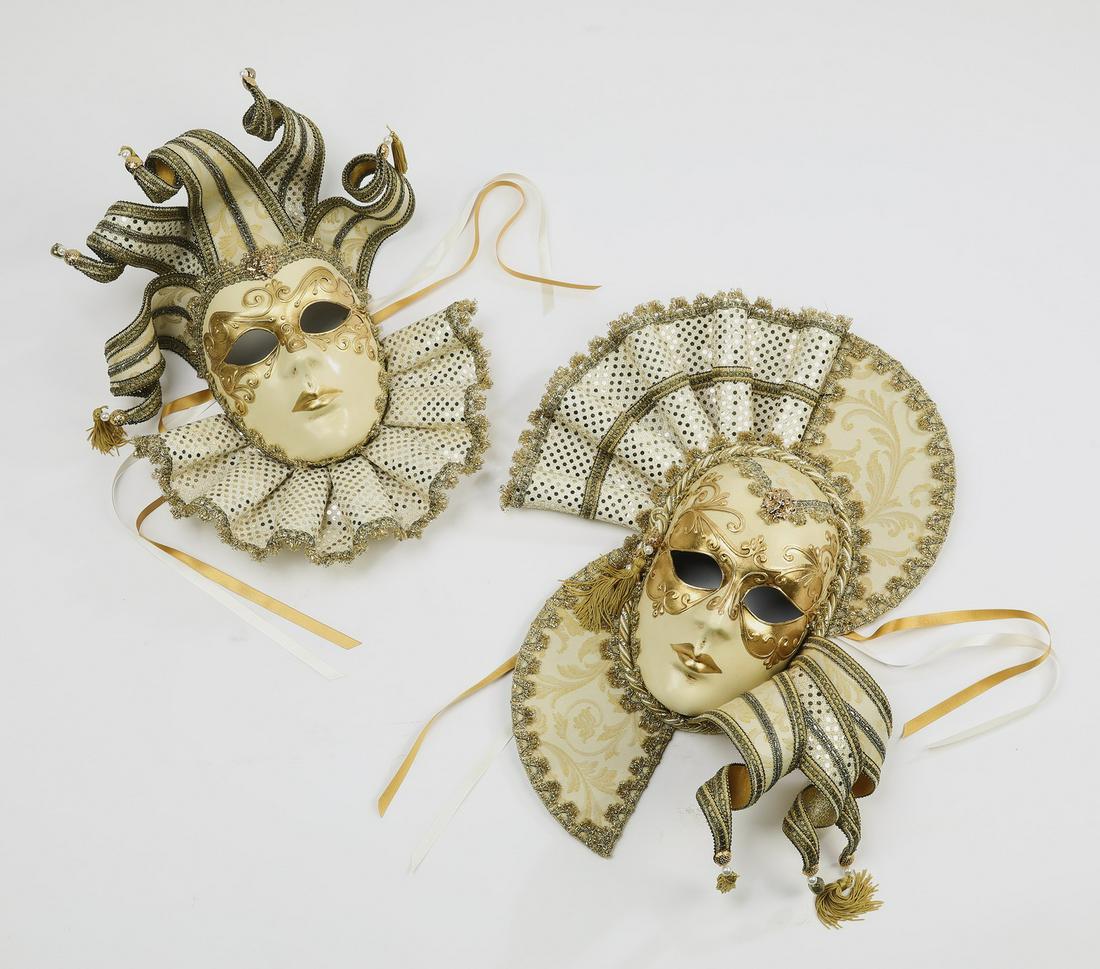 (2) Hand made Venetian Carnival masks: Pair of hand made Due-Bi full face Venetian Carnival masks, executed in papier mache, white and gold jacquard fabric, passementerie, and brass bells, depicting male and female jesters with hand painte