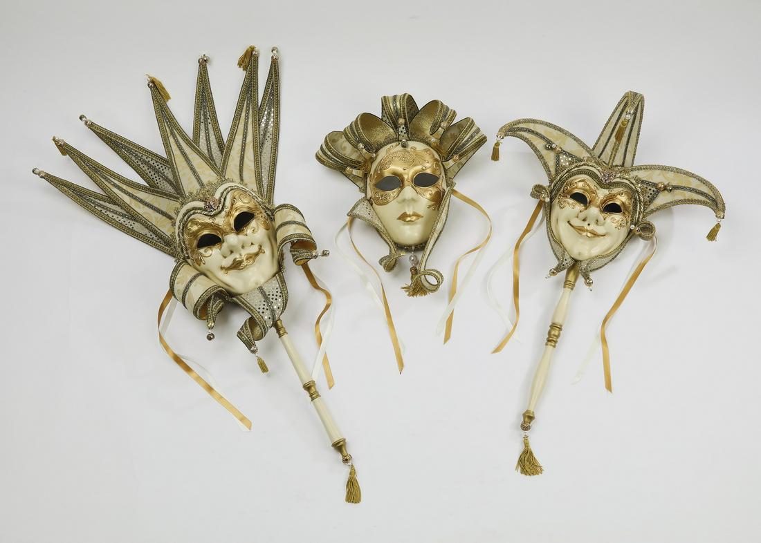 (3) Hand made Venetian Carnival masks: Group of three hand made Due-Bi full face Venetian Carnival masks, executed in papier mache, white and gold jacquard fabric, passementerie, and brass bells, depicting male and female jesters with hand