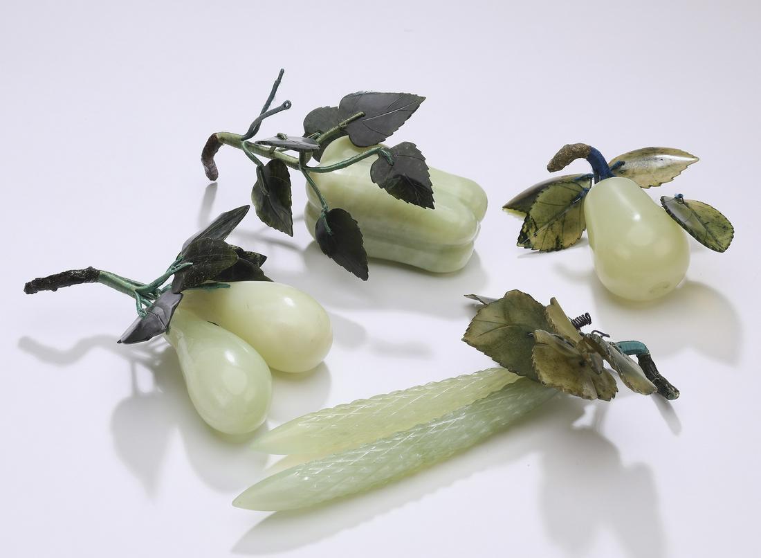 (4) Chinese carved jade fruits: Group of four Chinese carved jade fruits, including bitter melon, pepper, and pears, largest 7.5"l