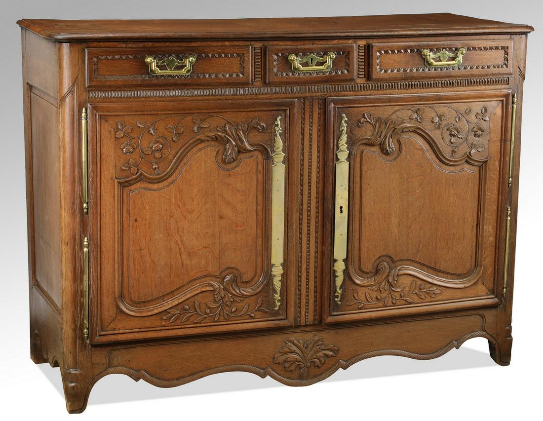 19th c. French Lyonnais carved oak buffet, 56"w: Late 19th century French Lyonnais oak buffet, the rectangular top surmounting the three drawer over two door case, the drawers with lamb's tongue borders above the relief carved doors with trailing vi