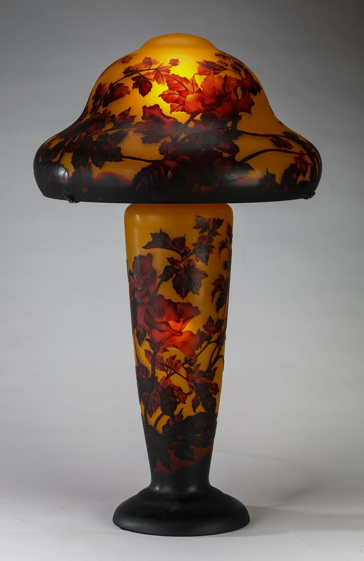 Art Nouveau style cameo glass lamp, 33"h: Art Nouveau style cameo glass lamp, in the manner of Emile Galle' (French, 1846-1904), having a graduated dome shade and tapering standard, in shades of amber, brown, and red, the outer colored glass 