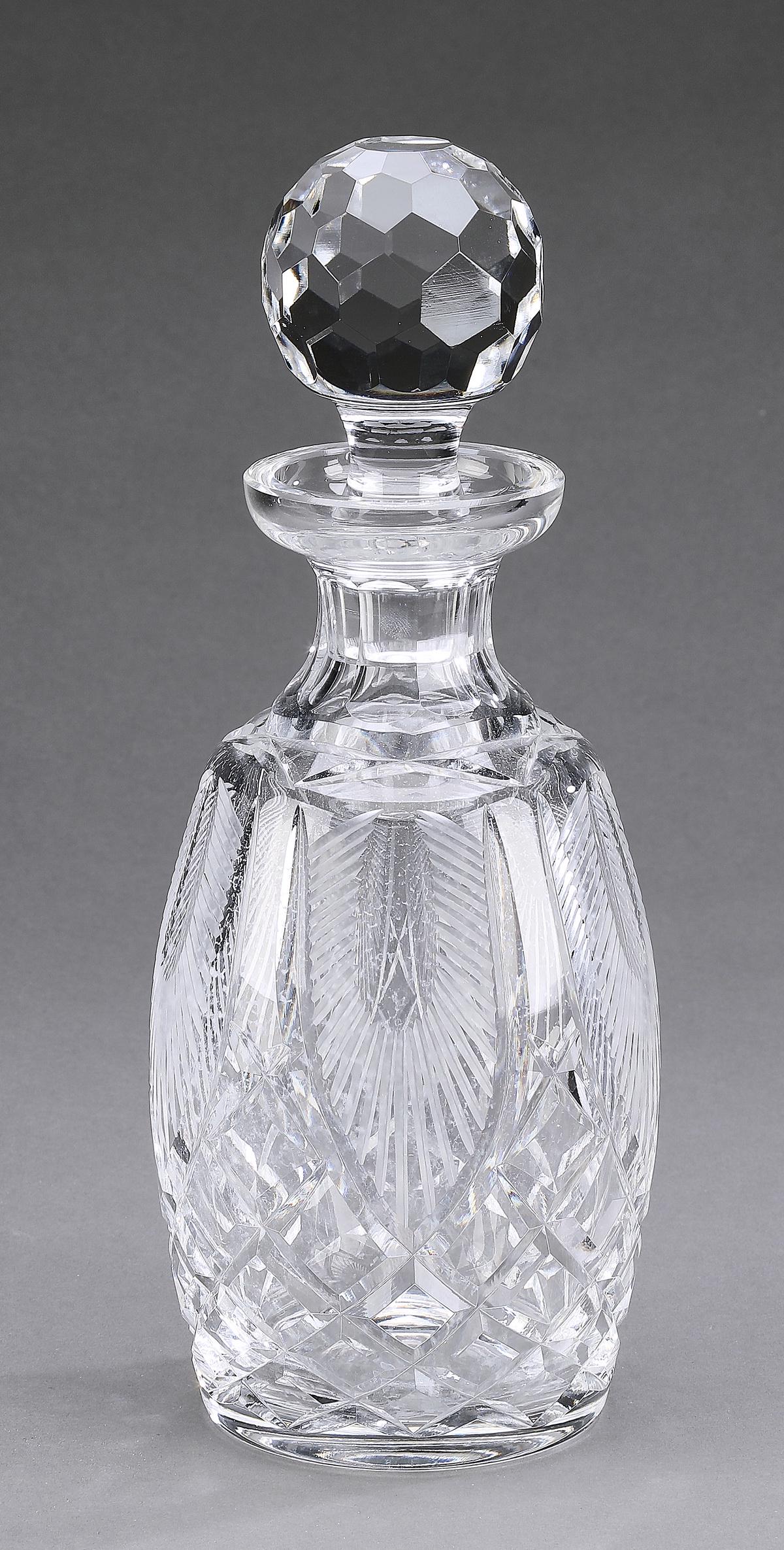 Waterford crystal decanter, marked: Waterford crystal decanter, having a round faceted stopper above an ovoid body cut with fans and a criss-cross pattern, maker marked, 11"h x 4"dia.
