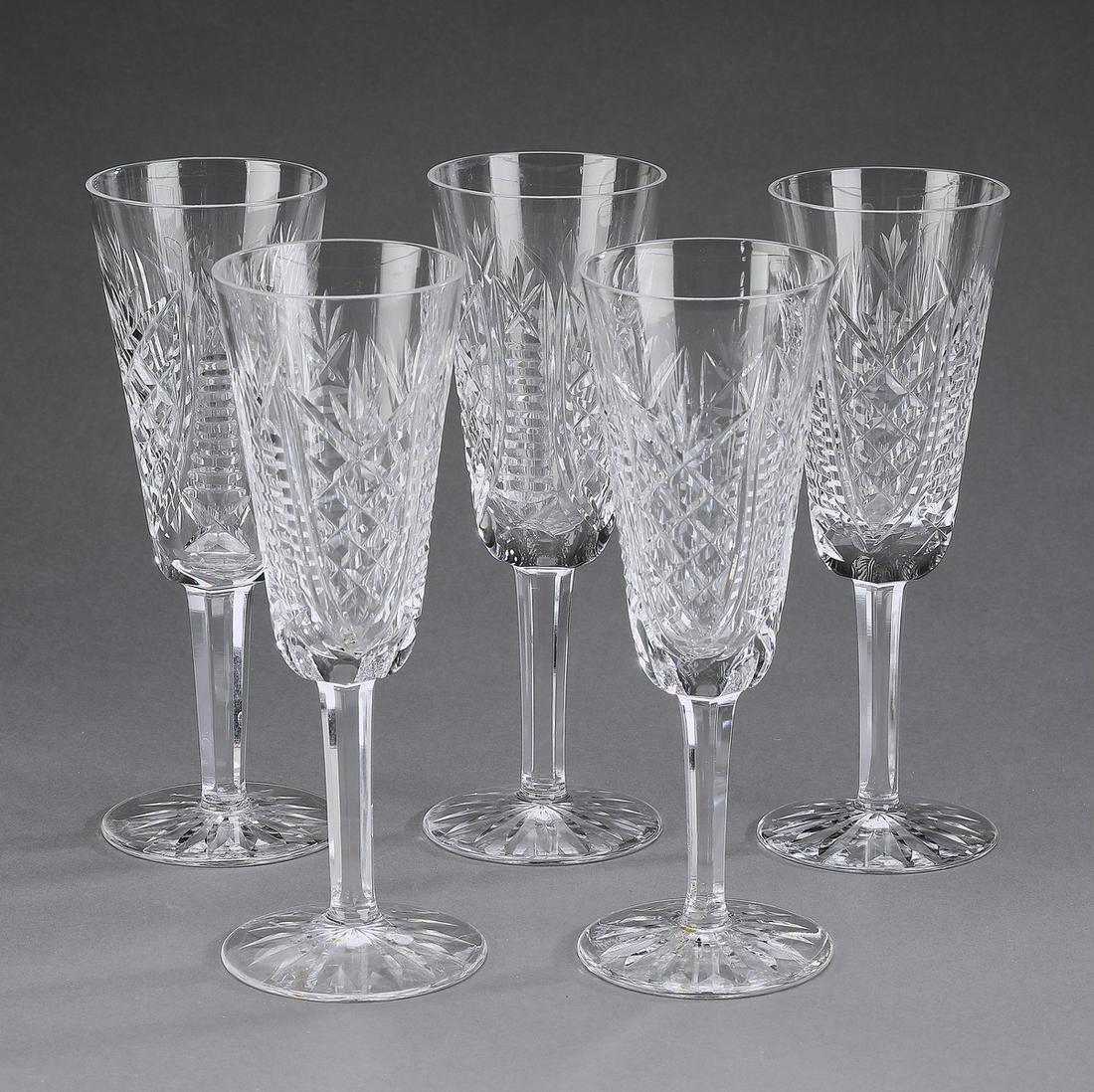 (5) Waterford crystal champagne flutes, marked: Set of five Waterford champagne flutes in the 'Clare' pattern, having crosshatched bowls rising on faceted stems, maker marked, 7.25"h x 2.5"dia.