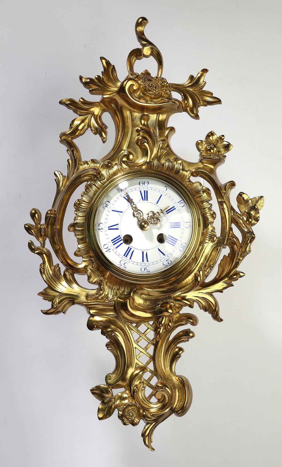 19th c. Japy Freres gilt brass cartel clock: Late 19th century Japy Freres Rococo Revival gilt brass cartel clock, of asymmetrical form with undulating acanthus 'C' and 'S' scrolls, centering a white enamel dial with blue Roman and Arabic numera