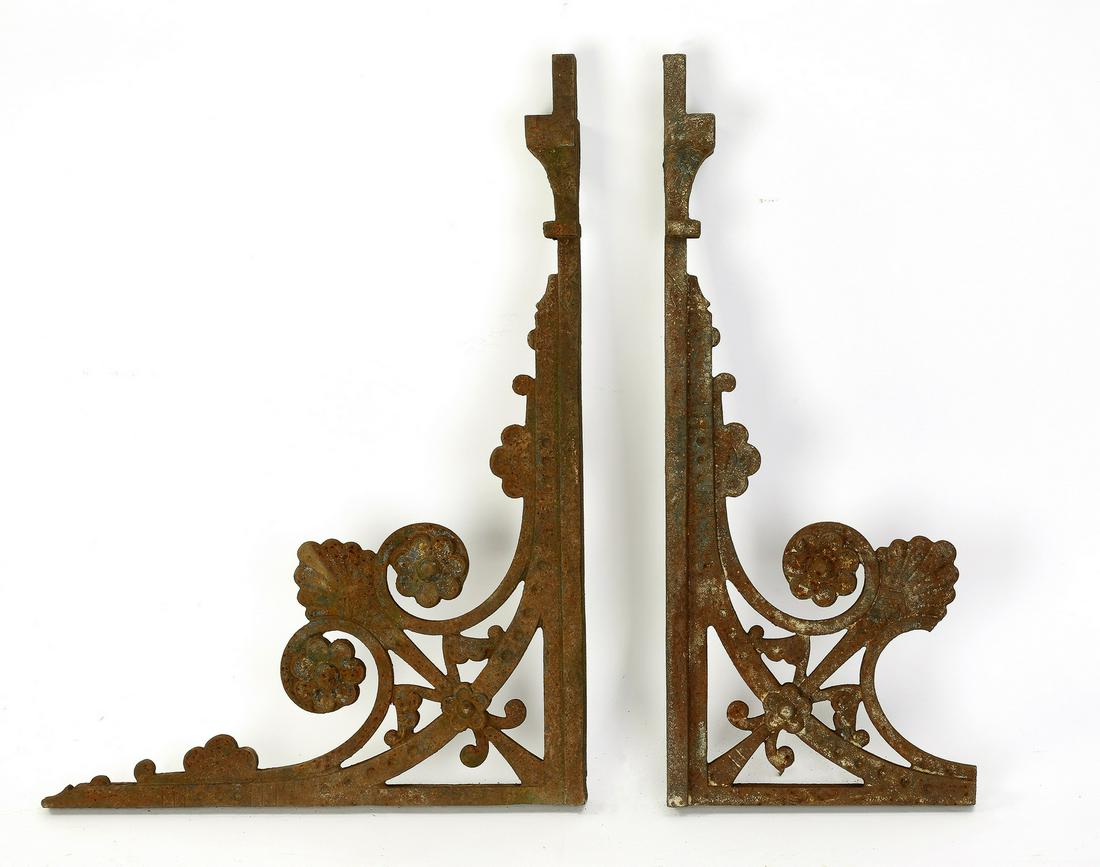 (2) 19th c. cast iron architectural brackets, 26"h: Pair of 19th century cast iron architectural brackets, each of pierced form with acanthus leaves and rosettes, (1) measuring 26.25"h x 19.25"w x 3.5"d, and (1) measuring 26.25"h x 10.75"w x 3.5"d.