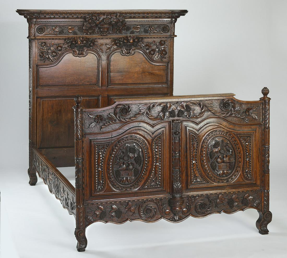 Late 18th c. French hand carved oak bed: Late 18th century French hand carved oak bed, having a molded cornice and pierce-carved floral arrangement medallion above a carved rosette frieze, and raised on molded panels relief carved with flowe