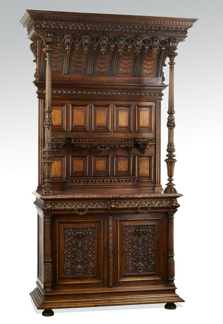 19th c. French carved walnut marble top buffet: Monumental 19th century French walnut and marble buffet in the Renaissance taste, the top having a dentil molded cornice supported by double columns raised on hairy paw feet, sheltering a paneled back