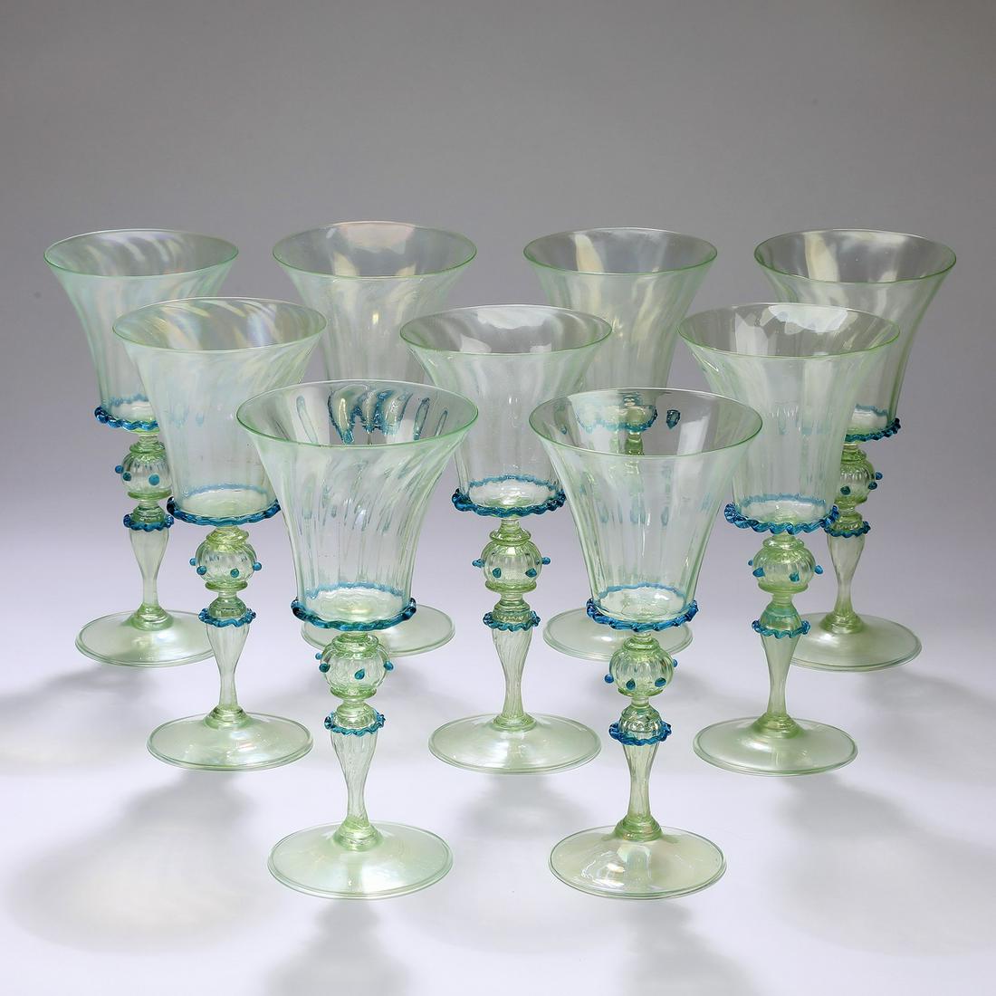 (9) Murano green art glass wine goblets: (9) Murano green art glass wine goblets, in the manner of Salviati, executed in green glass with applied ruffled blue trailed glass and beads, each having a bell shaped dip-molded bowl, rising on a st