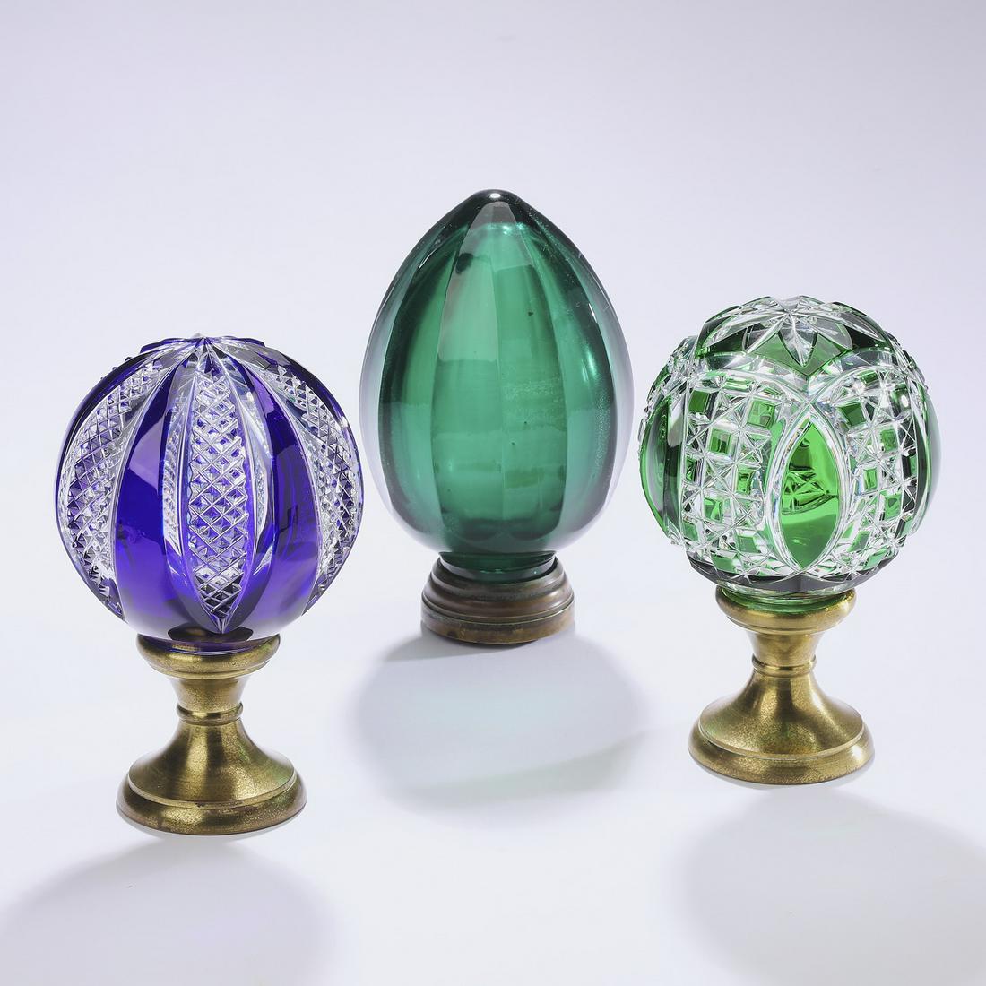 (3) Early 20th c. French crystal newel post finials: Three crystal newel post finials, early 20th century, comprising: (1) French cobalt cut to clear finial, of spherical form, having an overall wedge pattern with crosshatching, rising on a brass socle 