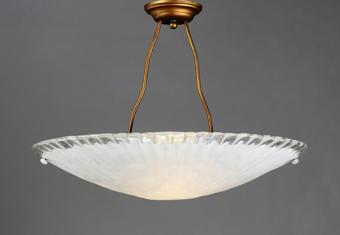 Italian hand blown copper and glass pendant light: Contemporary Italian hand blown 'scavo' or antiqued glass pendant light, having a circular copper plate issuing two undulating tubes, suspending a shallow oval shaped glass bowl with gadrooning and sc
