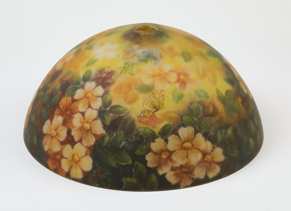 Reverse painted glass floral lamp shade: Reverse painted lamp shade, of dome form, decorated in the round with butterflies flitting above floral sprays in melon, lemon, and green, on a lemon ground, 8"h x 13.75"dia; fitter 2"dia.