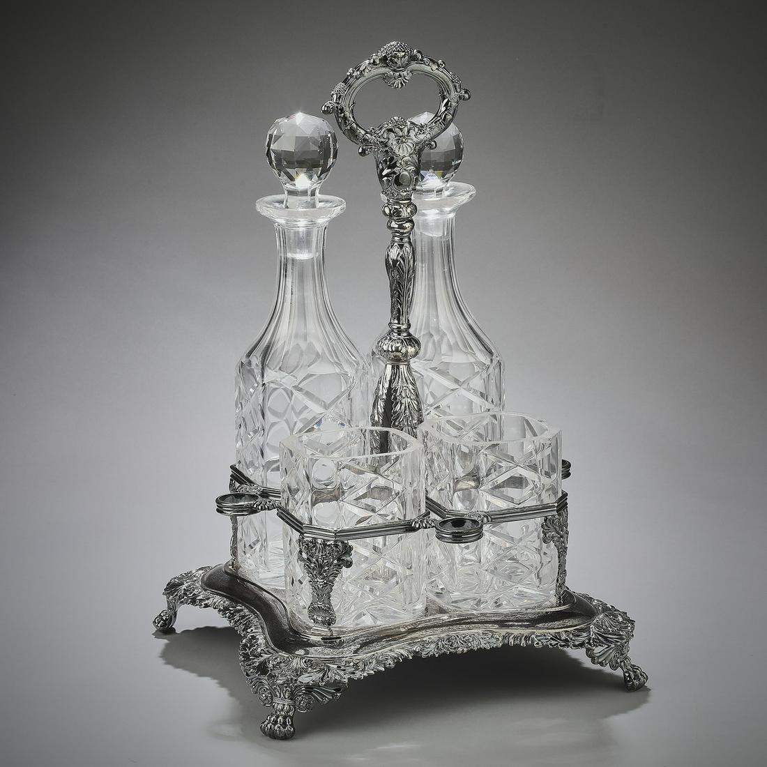 George IV style crystal condiment stand: Crystal and silver plated condiment stand in the George IV taste, having a foliate ring finial over a baluster standard, fitted with an armature for four containers, each container executed in clear c
