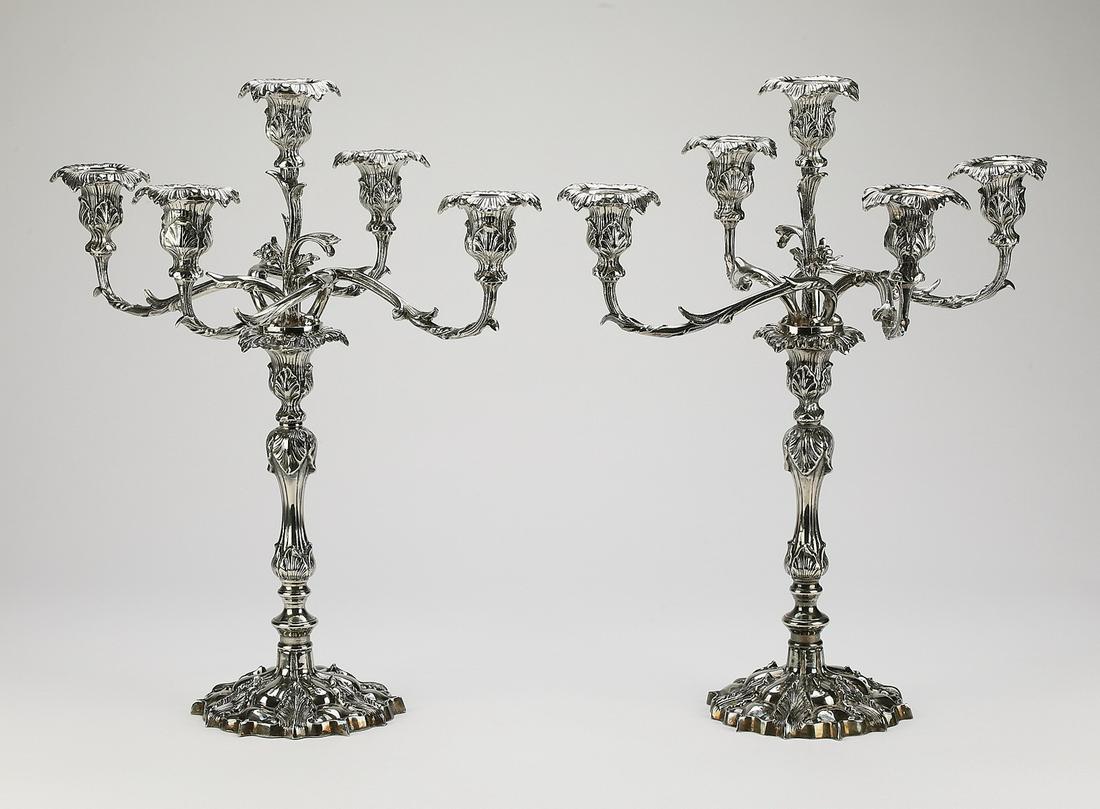 (2) Candelabra in the Renaissance Revival style: Pair of five light candelabra in the Renaissance Revival style, executed in spelter, having four foliate candle cups surrounding a center cup, all issuing from sinuous acanthus arms and surmounting a 