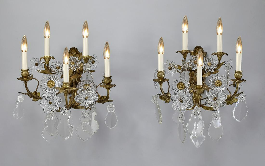 (2) Rococo style bronze 5-arm floral sconces: Pair of gilt bronze and crystal 5-arm floral sconces in the French taste, each having a Rococo cartouche-form backplate issuing five scrolling acanthus arms hung with French drops and multiple tendril