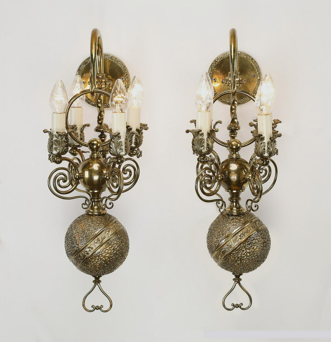 (2) Early 20th c. 4-light brass wall sconces: Pair of early 20th century 4-light Louis XIV style brass wall sconces, each having a circular plate issuing a hook suspending a four arm candelabra surmounting a vermicular orb terminating to a heart 