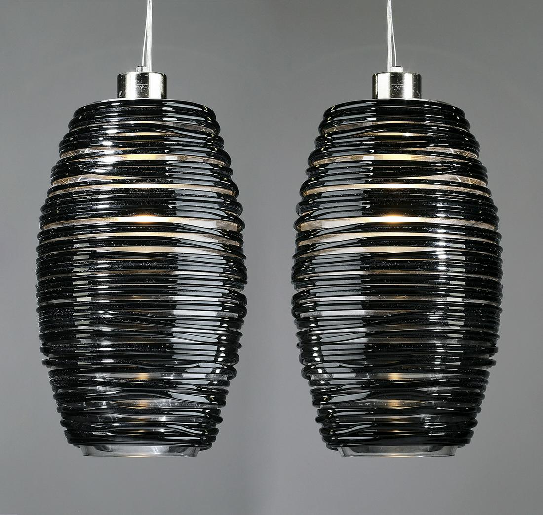 (2) Vistosi black Murano glass pendants: Pair of contemporary black Murano glass pendants, designed by Paolo Crepax for Vistosi, from the 'Damasco' series, each of barrel form, ornamented by a continuous thin coil of black glass tightly woun