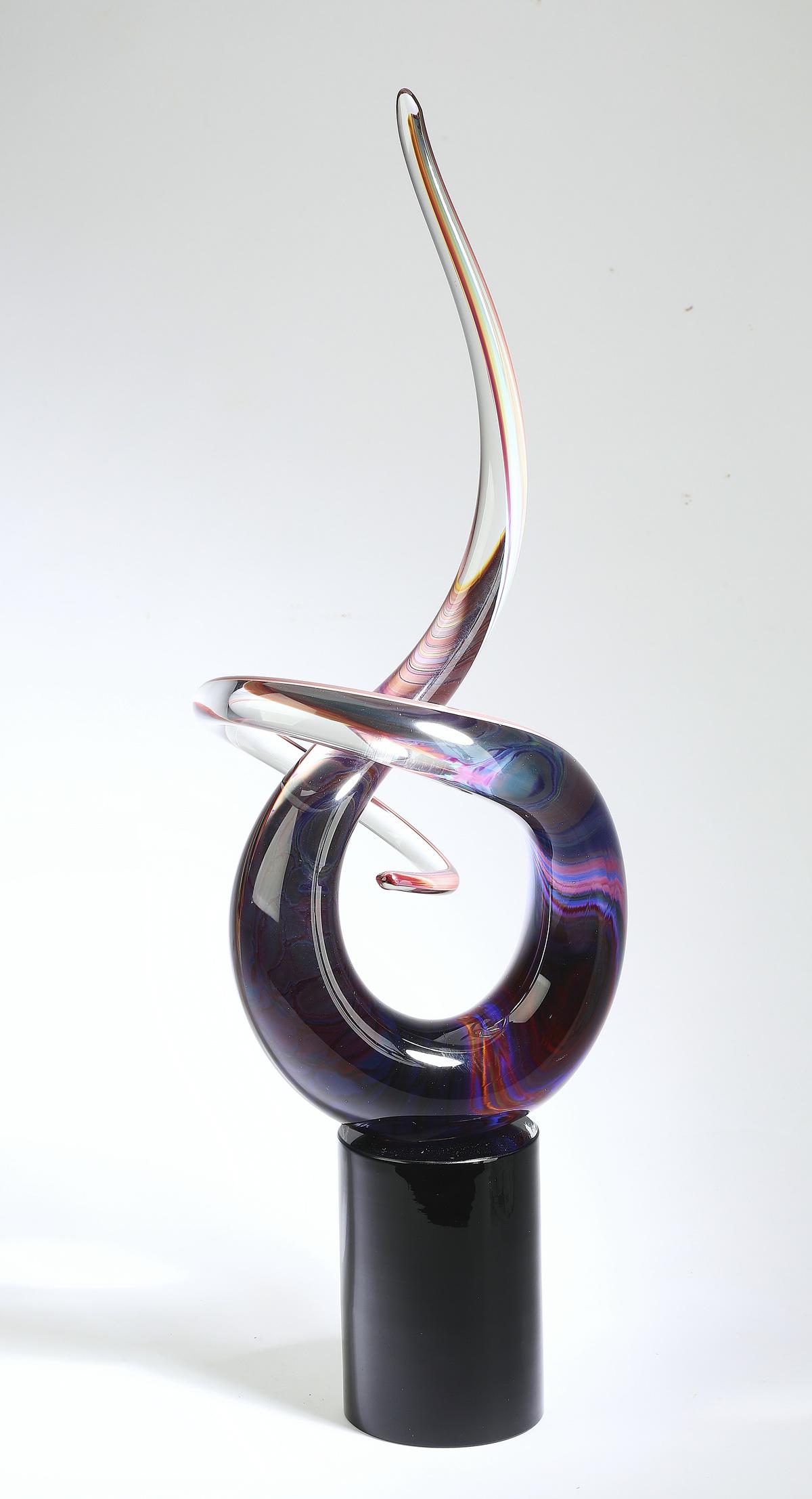 Murano abstract art glass sculpture, ca 1970: Murano abstract art glass sculpture, circa 1970, executed in dark amethyst shading to clear, raised on a black glass cylindrical base, having no apparent signature, 26.25"h x 7.75"w x 5.5"d.